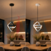 Suspension LED géométrique noire et blanche installée au-dessus d’une table